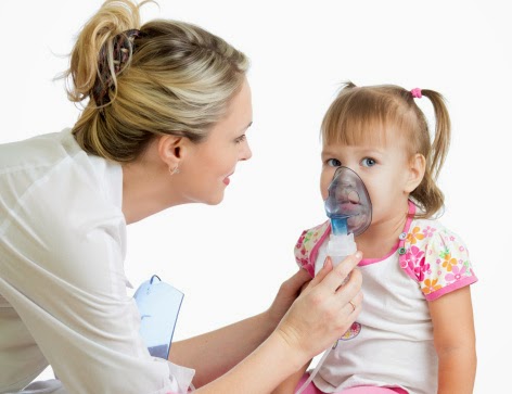 Doctor holding inhaler mask for kid girl breathing